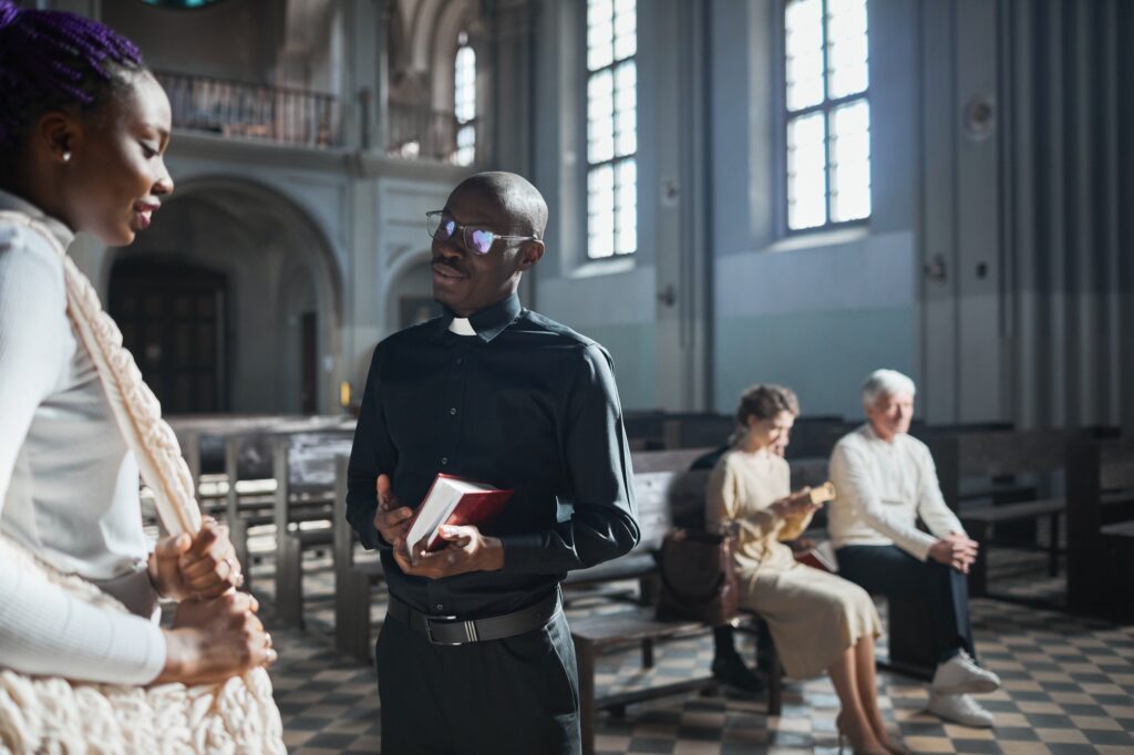priest talking to the faithful people jpg